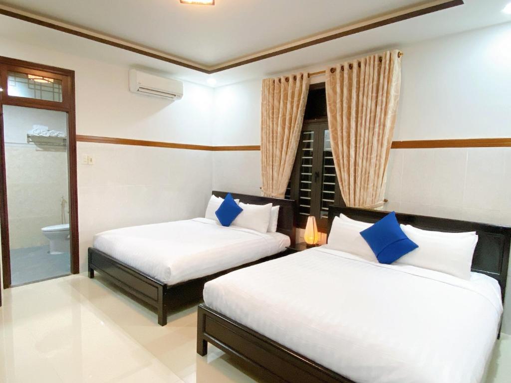 Postel nebo postele na pokoji v ubytování Serenity Villa Hoi An