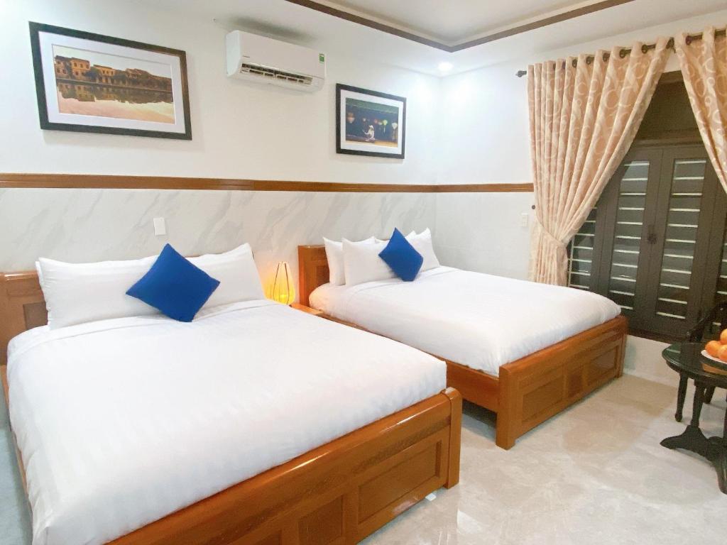 Postel nebo postele na pokoji v ubytování Serenity Villa Hoi An