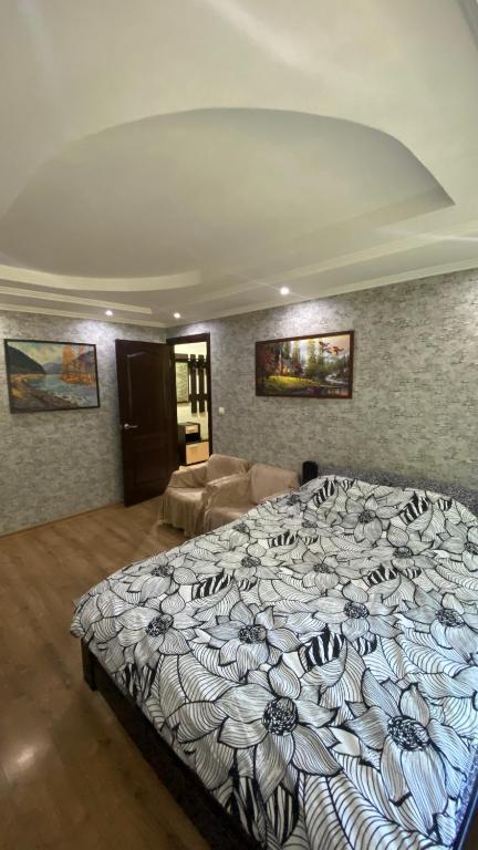 a bedroom with a large bed in a room at Квартира на Проспекті in Uzhhorod