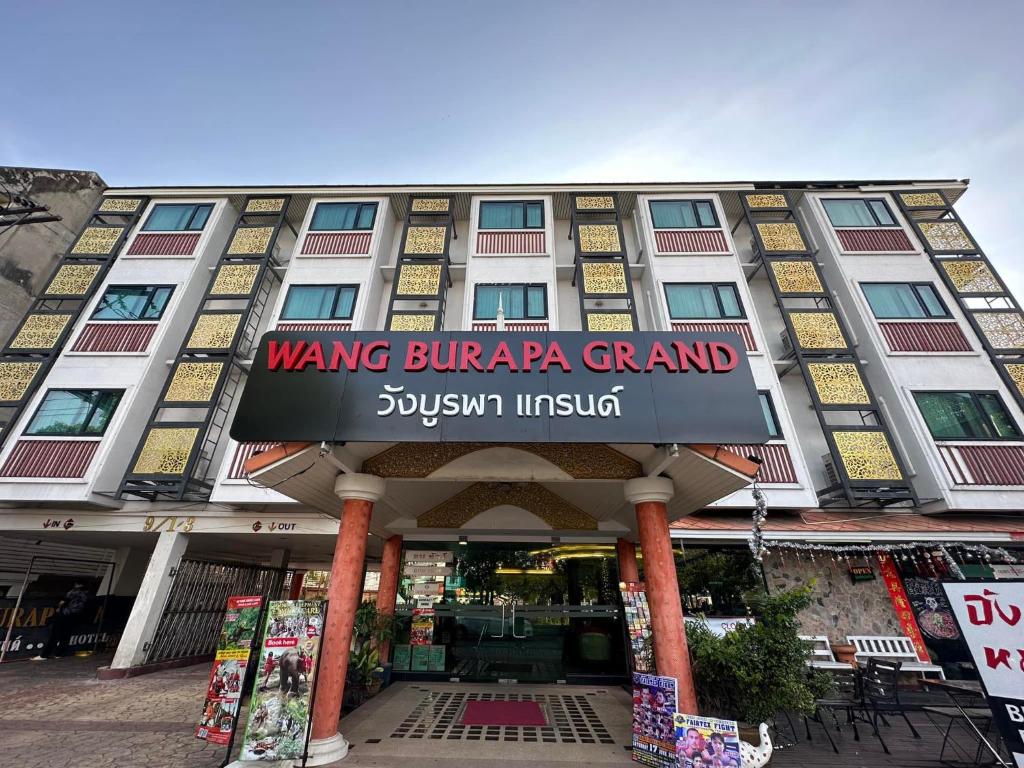 a building with a sign on the front of it at Wangburapa Grand Hotel in Chiang Mai