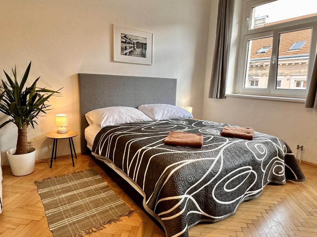 a bedroom with a bed with two pillows on it at Pension SKLEP in Prague