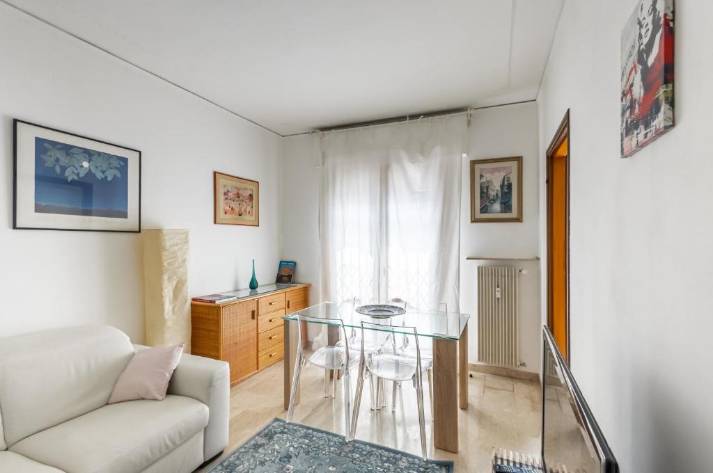 a living room with a glass table and a couch at Kris- Mestre Bright Apartment with Parking! in Mestre
