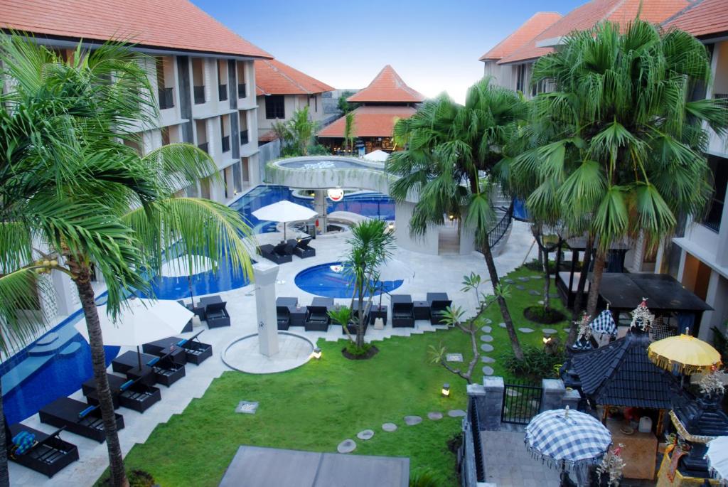 an aerial view of a resort with a pool and palm trees at Grand Barong Resort in Kuta