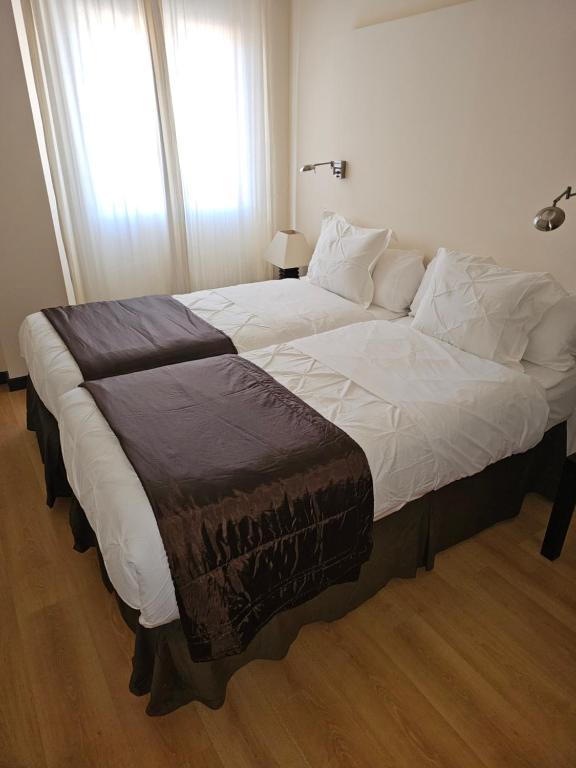 Postel nebo postele na pokoji v ubytování hotel asador versus