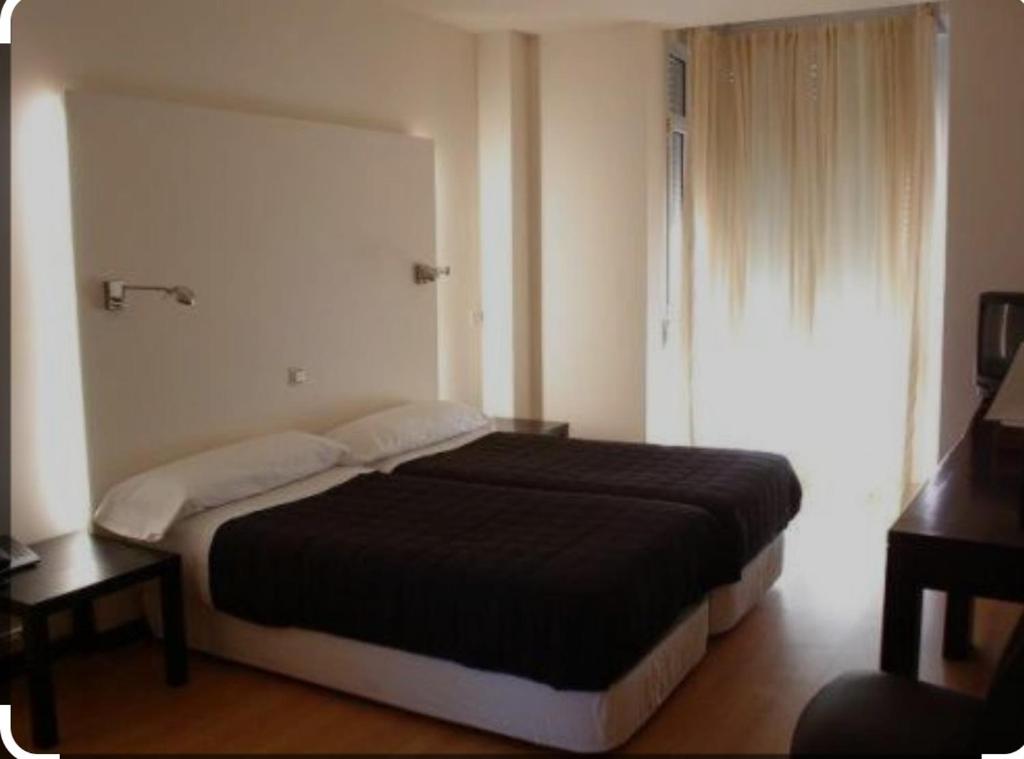 Postel nebo postele na pokoji v ubytování hotel asador versus