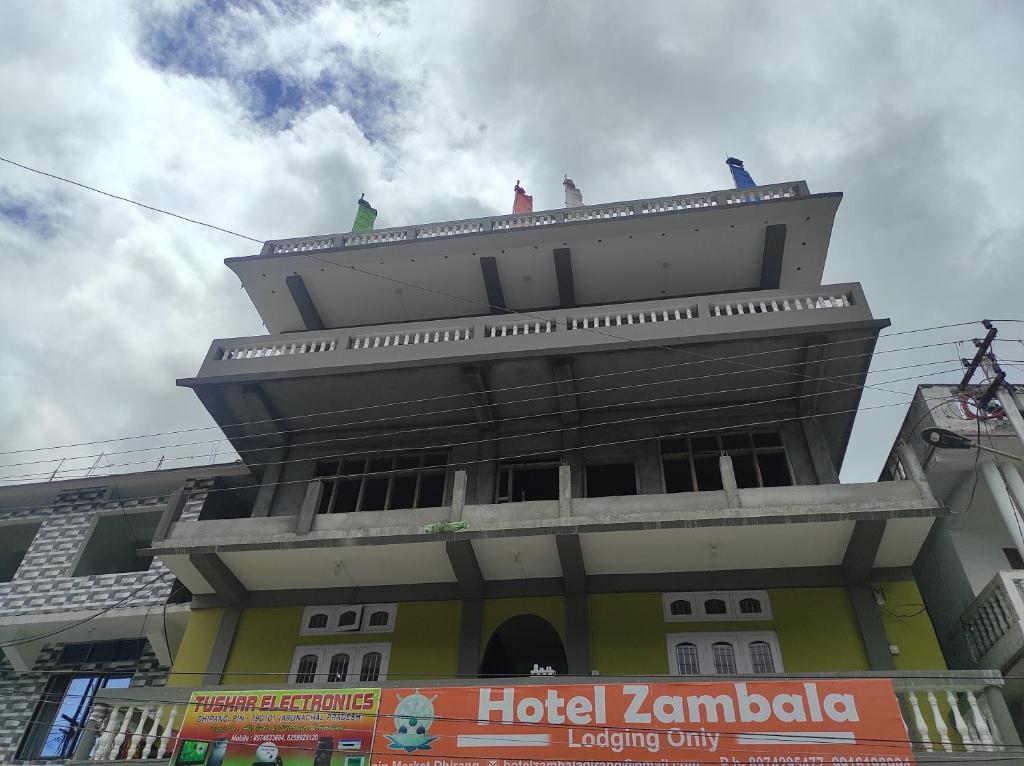 a building with people sitting on the top of it at Hotel Zambala in Dirang Dzong