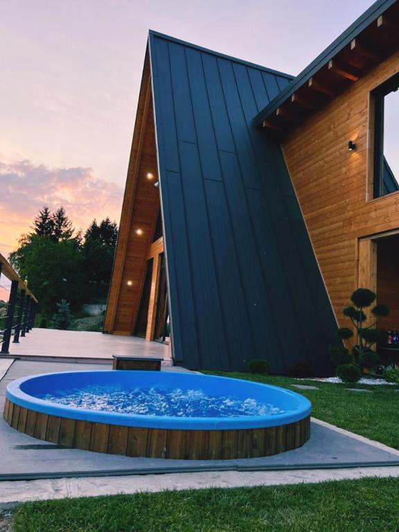 a large blue fountain in front of a building at Cabana Ana in Borşa