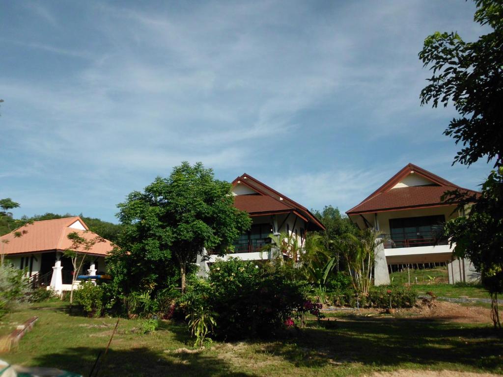 a house with a tree in front of it at Seagull Villa in Ko Lanta