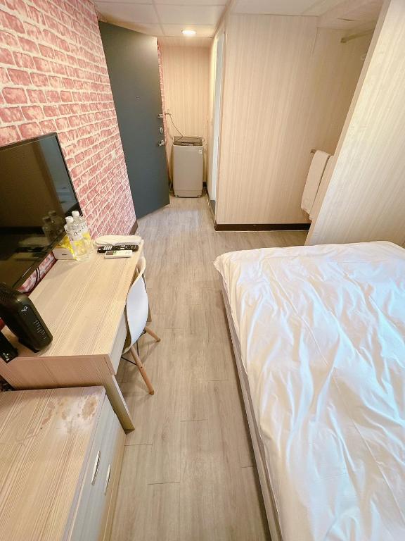 Postel nebo postele na pokoji v ubytování 新獅城商務旅館New Lion City Hotel