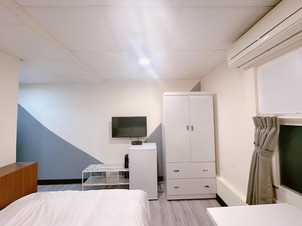 Postel nebo postele na pokoji v ubytování 新獅城商務旅館New Lion City Hotel