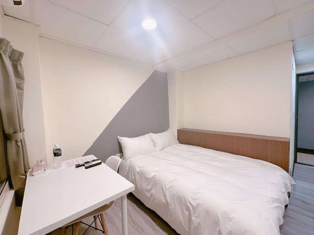 Postel nebo postele na pokoji v ubytování 新獅城商務旅館New Lion City Hotel