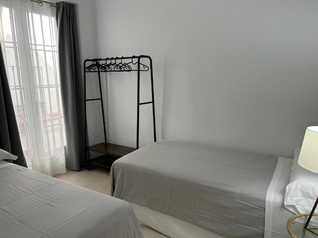 Postel nebo postele na pokoji v ubytování Olavide Premium Apartments