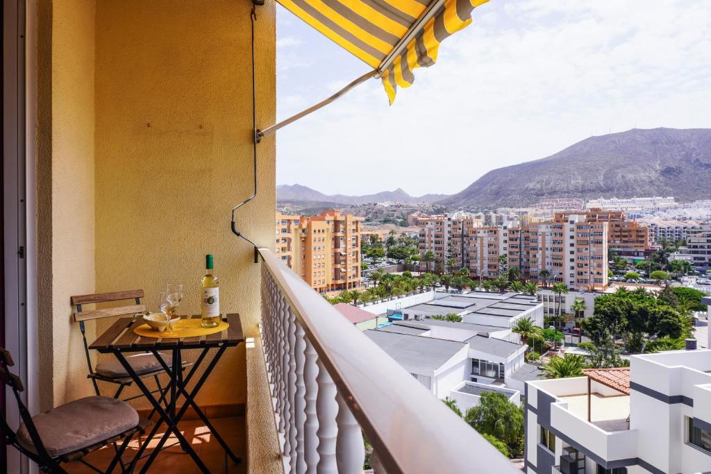 a balcony with a table and an umbrella at Comfy Home in Los Cristianos in Arona