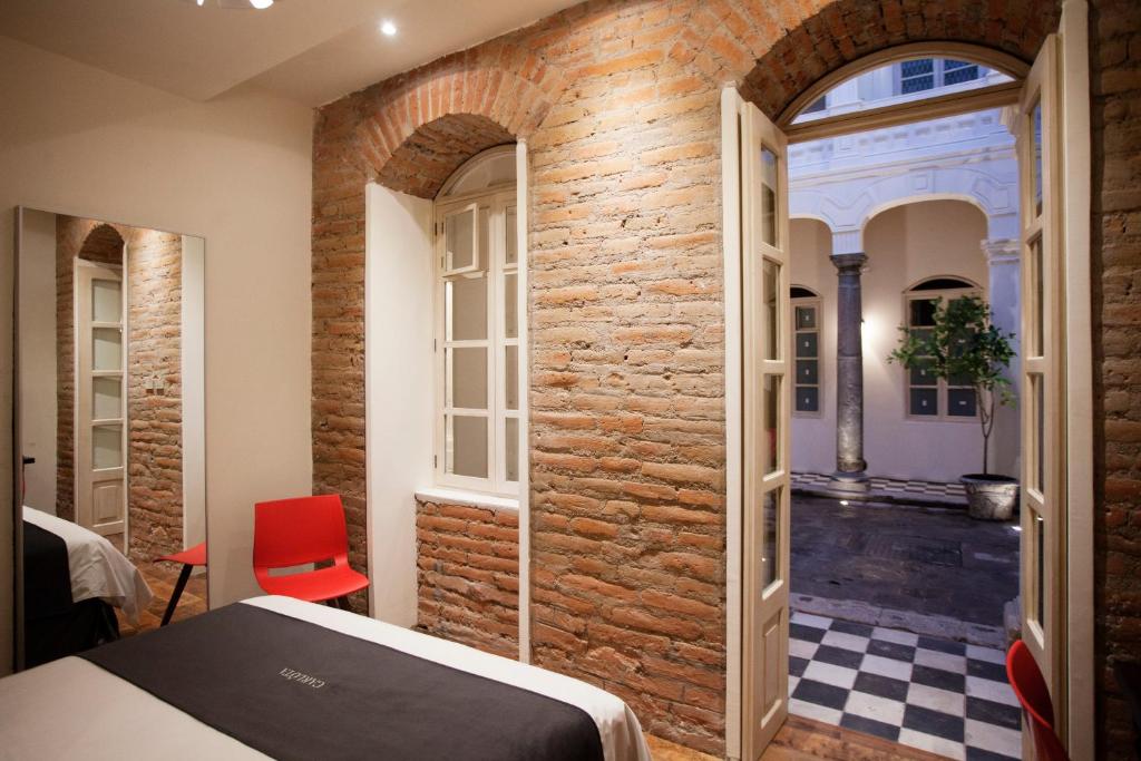 Postel nebo postele na pokoji v ubytování Carlota Sustainable Design Hotel