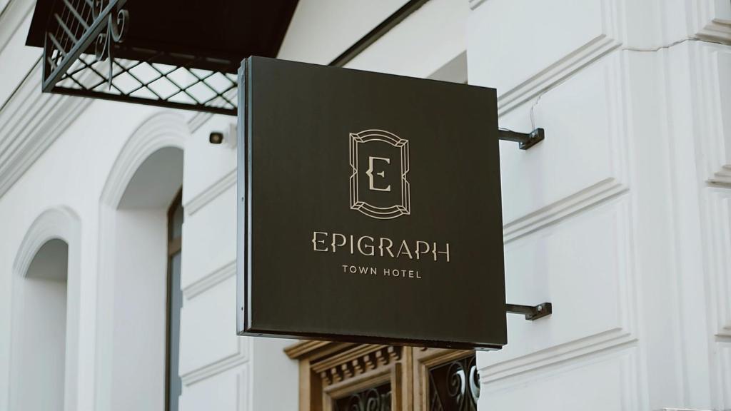 una señal colgando en el lateral de un edificio en EPIGRAPH Design Hotel en Tiflis