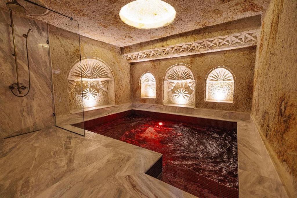 a large bathroom with an aquarium in the floor at Canyon Cave Hotel in Urgup