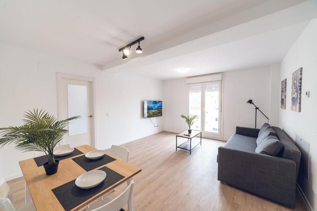 a living room with a couch and a table at ALFALFA B Apartments in Madrid