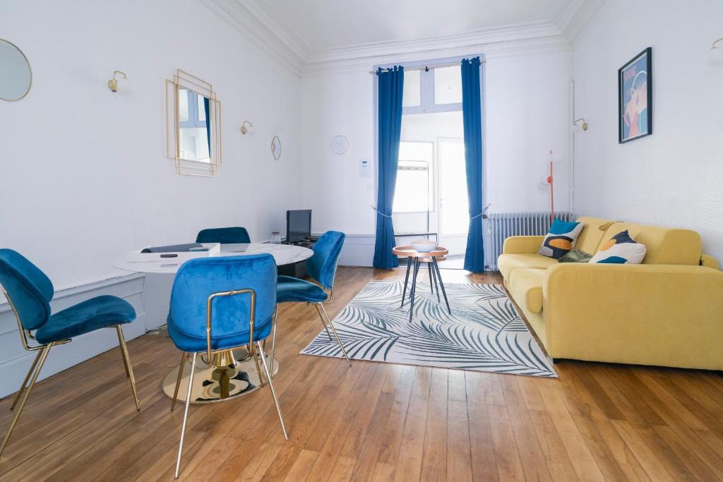 a living room with a yellow couch and blue chairs at La Verrière by la Maison de Marc- Poitiers Centre - parking et terrasse in Poitiers