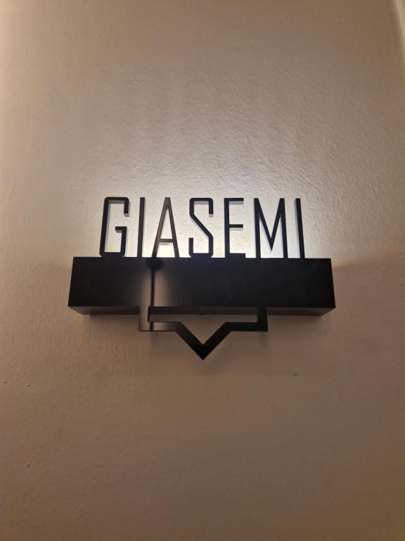 a sign that reads glisan hanging on a wall at Jensen Luxury Suites in Rhodes Town