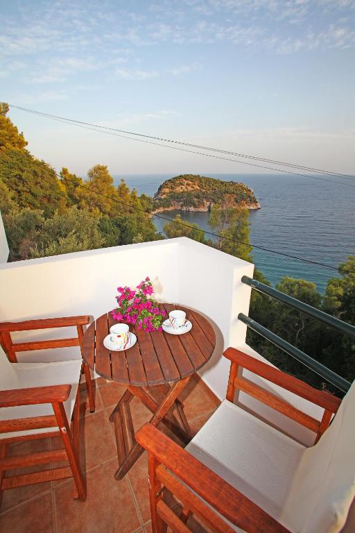 a balcony with a table and chairs and the ocean at Kalithea Studios in Stafylos