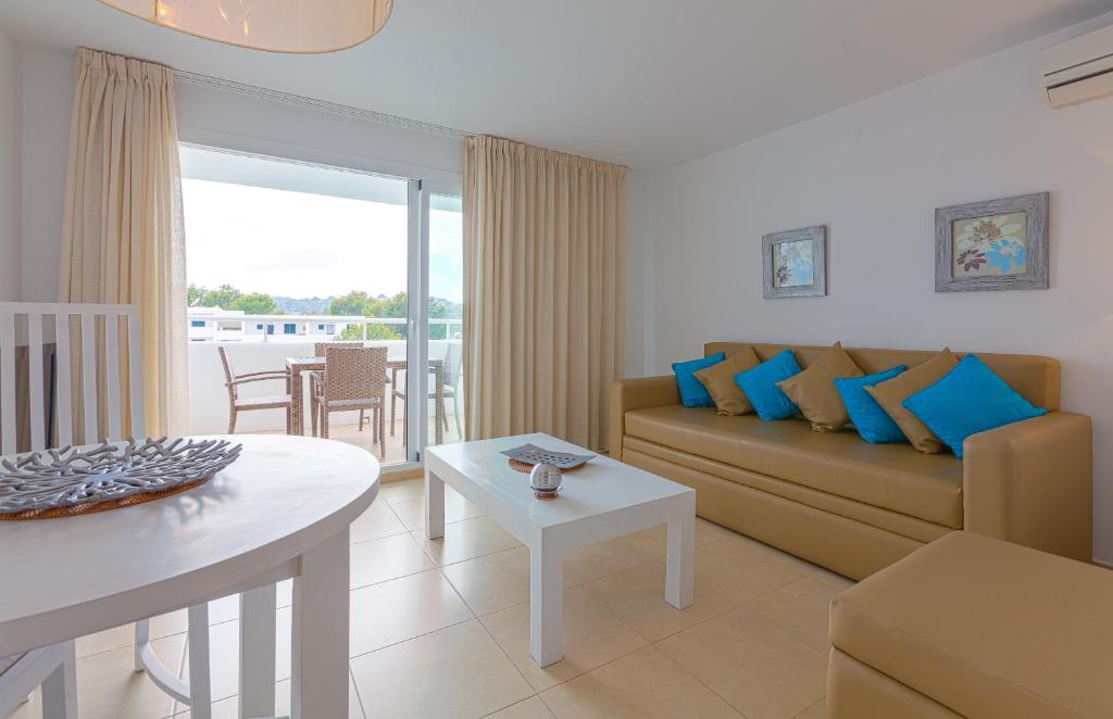 a living room with a couch and a table at Camelina Suites in San Antonio Bay