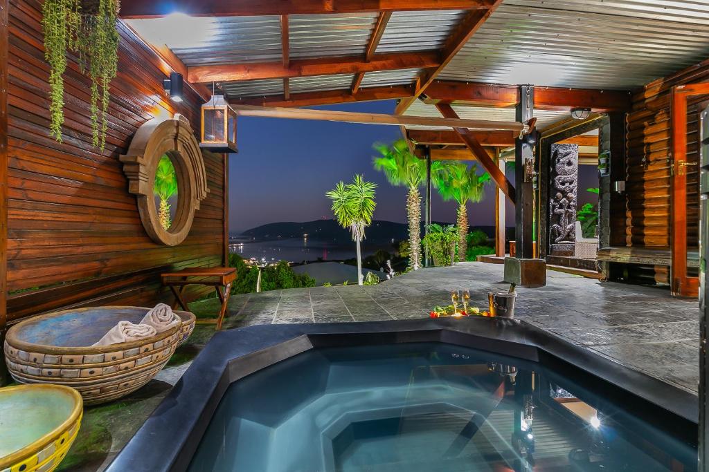 a swimming pool in a house with a patio at Knysna Lodge - Self Catering Accommodation with Woodfired Hot Tub in Knysna