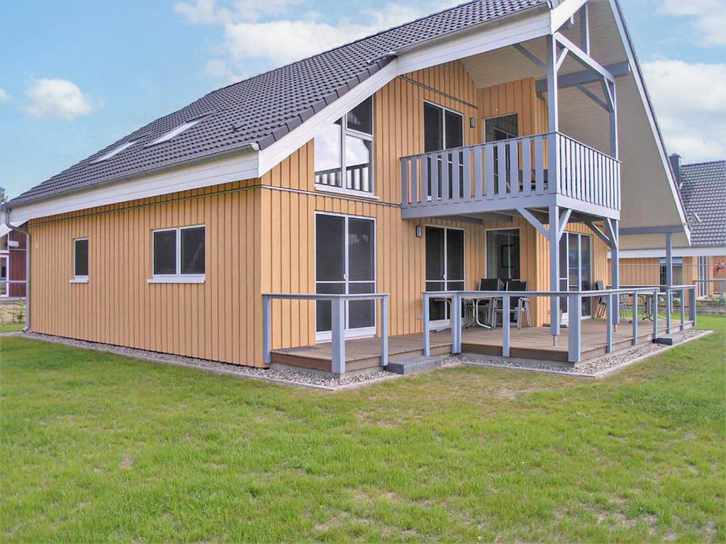 a large house with a deck on the side of it at Holiday Home Schwan by Interhome in Granzow