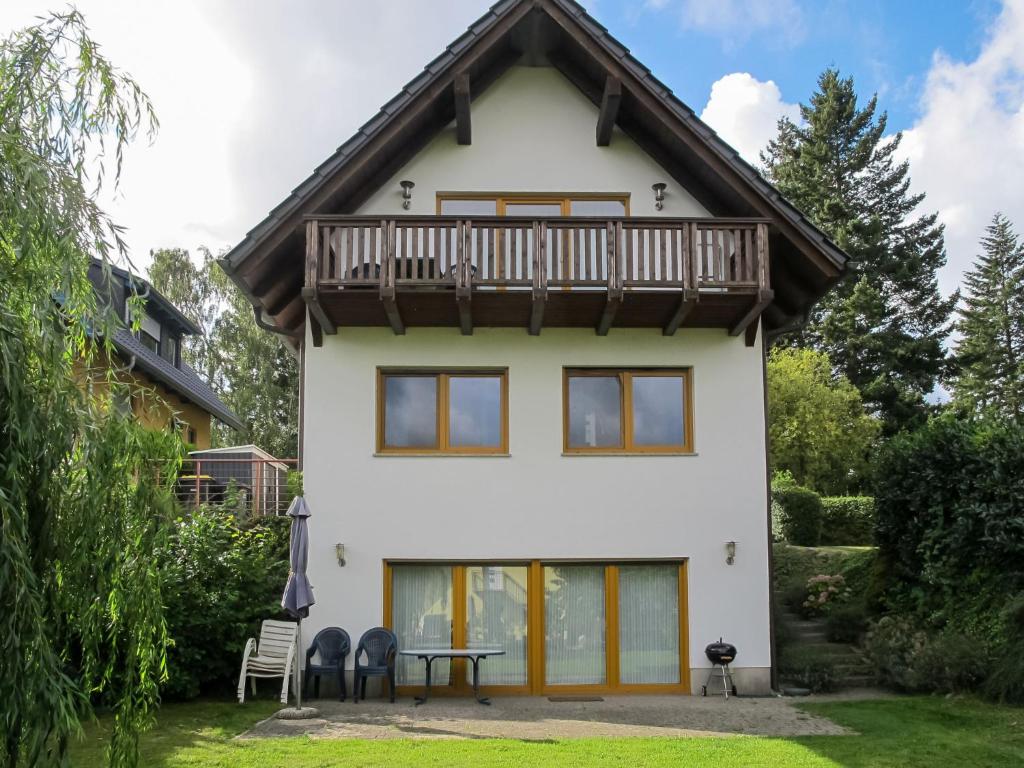 a house with a balcony on top of it at Holiday Home Müritz Ferienpark Röbel-22 by Interhome in Röbel