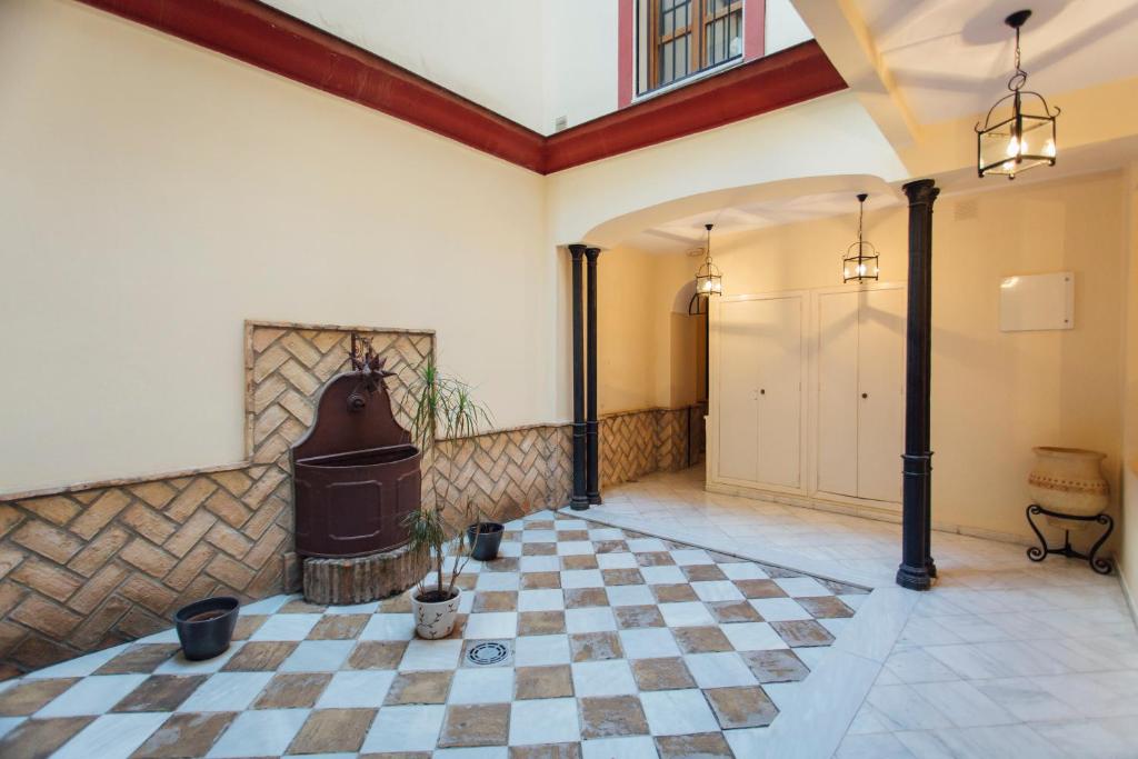 a room with a checkered floor and a fireplace at Beautiful and cozy- 1Bd 1Bth- Arenal Center in Seville