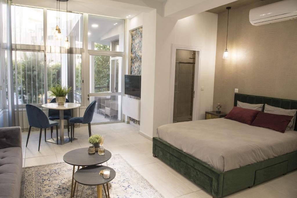 a bedroom with a bed and a living room at STAY Glam Skin Studio in Nicosia