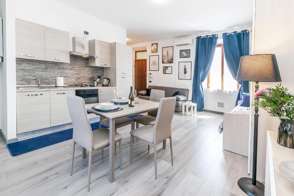 a kitchen and dining room with a table and chairs at RHOme 8 - 4 minutes from Rho Fiera in Rho