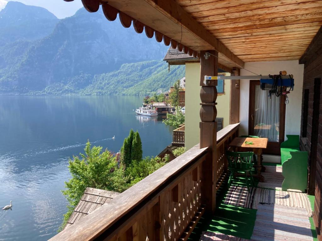 a balcony of a house with a view of a lake at Privatzimmer am See in Hallstatt