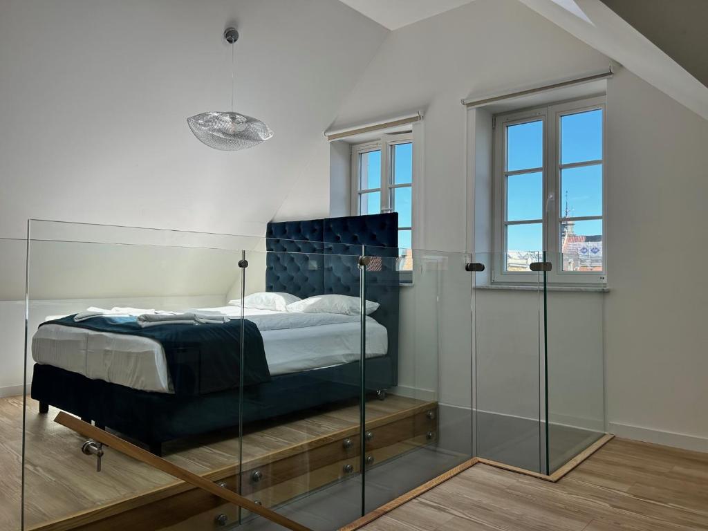 グダニスクにあるBaltic Gdańsk OLD TOWN by St Mary s Churchのベッドルーム1室(ガラス張りのベッド1台付)