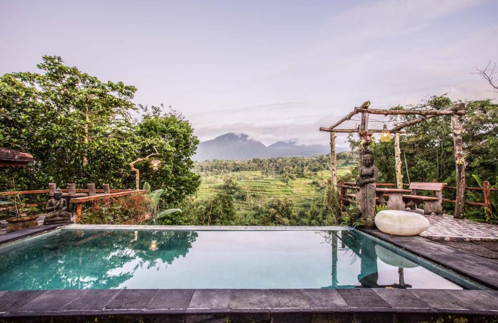 a pool in a villa with a view of a mountain at Pondok Nyoman in Bedugul