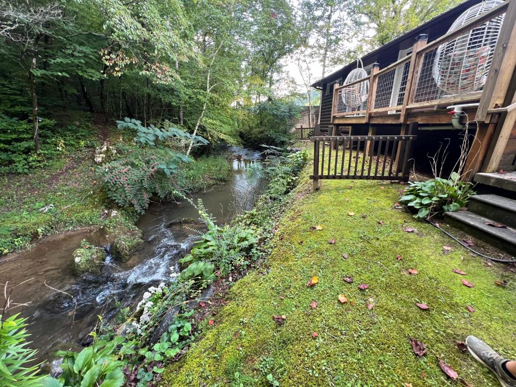 a train traveling down a stream next to a river at Creekside Haven in Gatlinburg