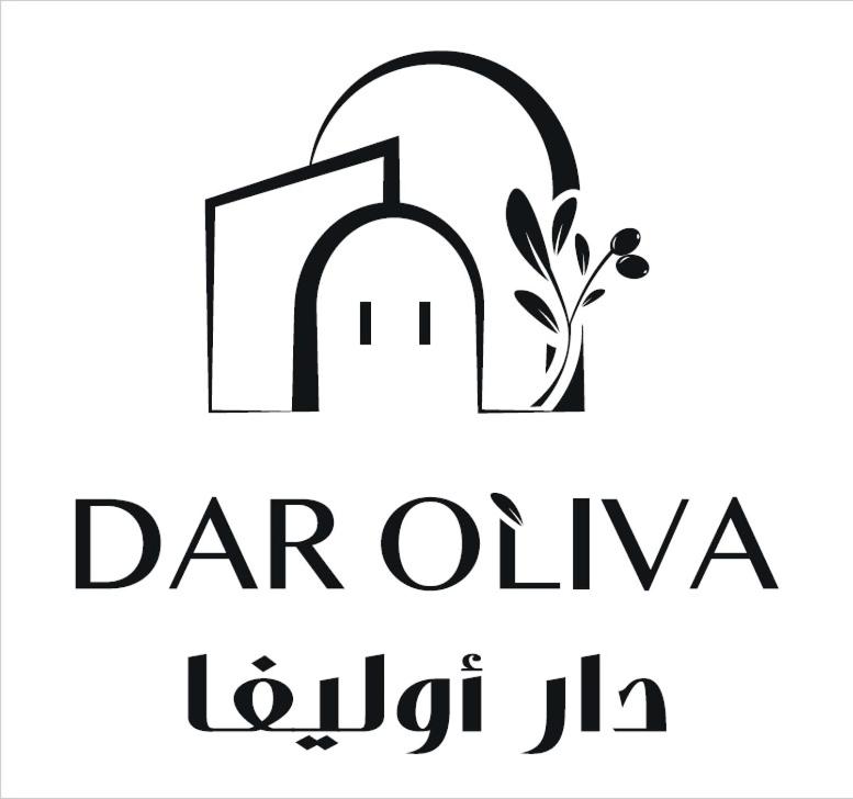 a logo of a door and a plant at Dar Oliva Maison de luxe in Houmt Souk