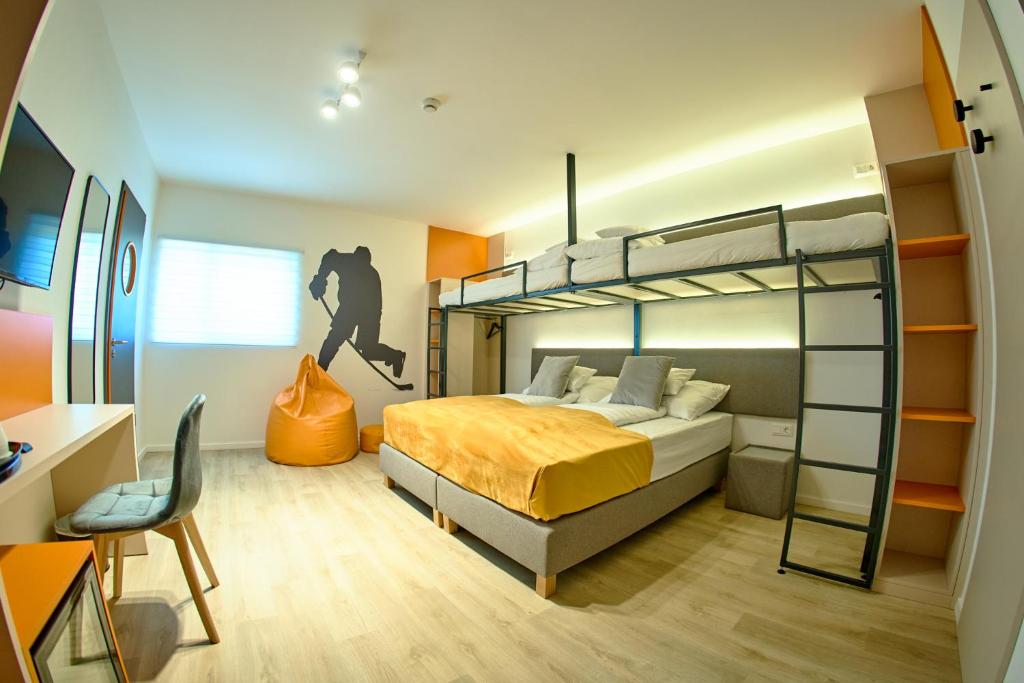 a bedroom with a bunk bed and a desk at Ice Premium Apartments in Veszprém