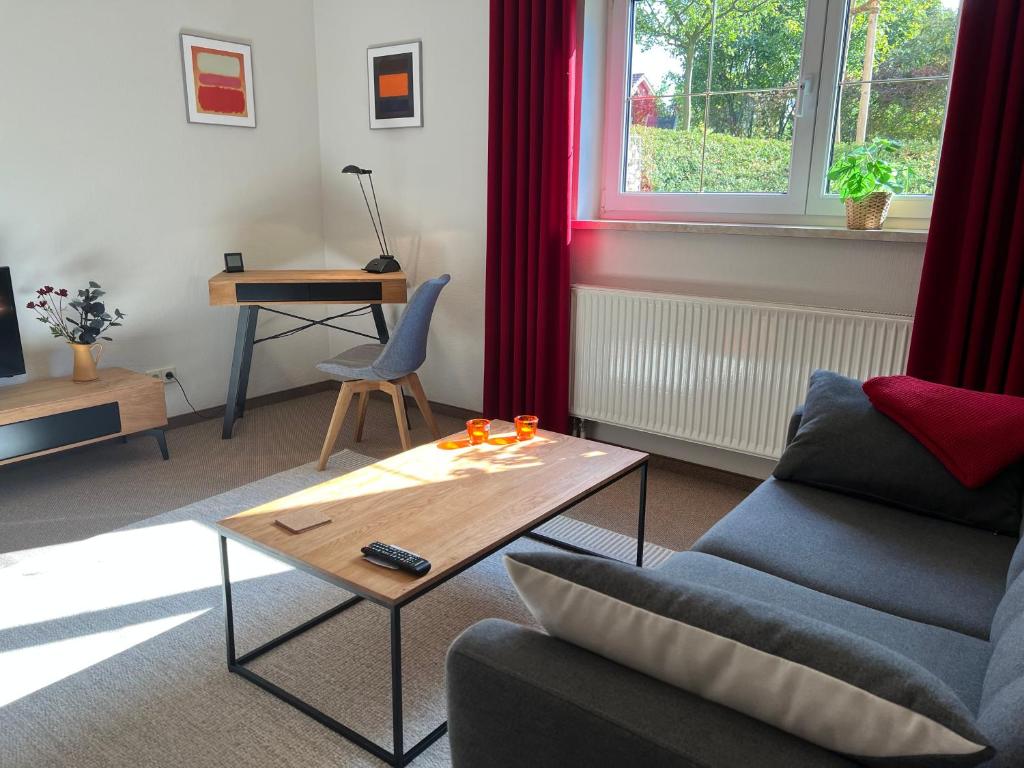 a living room with a couch and a coffee table at Appartement Am Weinberg in Radebeul