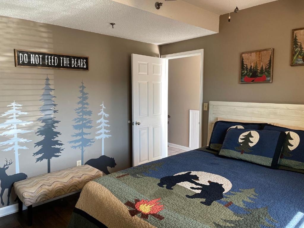 a bedroom with a bed with a blue comforter at The River Cottage in Pigeon Forge