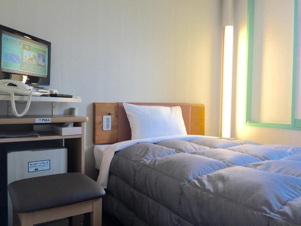 Postel nebo postele na pokoji v ubytování R&B Hotel Kobe Motomachi