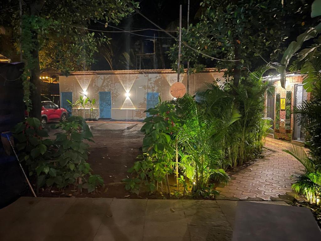 a night view of a house with a driveway at South Delhi restaurant and resort in Vagator