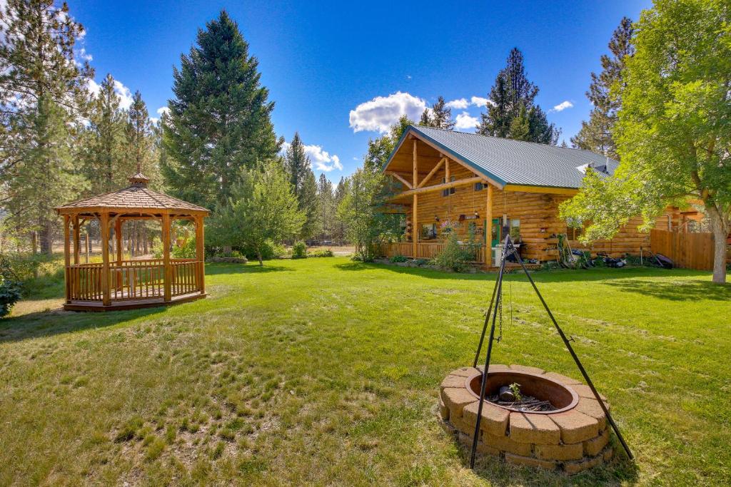 a log cabin with a gazebo in the yard at Libby Home with Mountain Views Gazebo and Fire Pit! in Libby