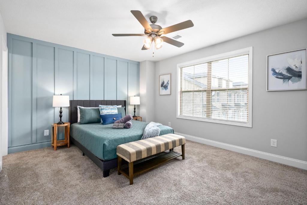 a bedroom with a bed and a ceiling fan at Modern 3-bedroom Close To Ft, Campbell in Clarksville
