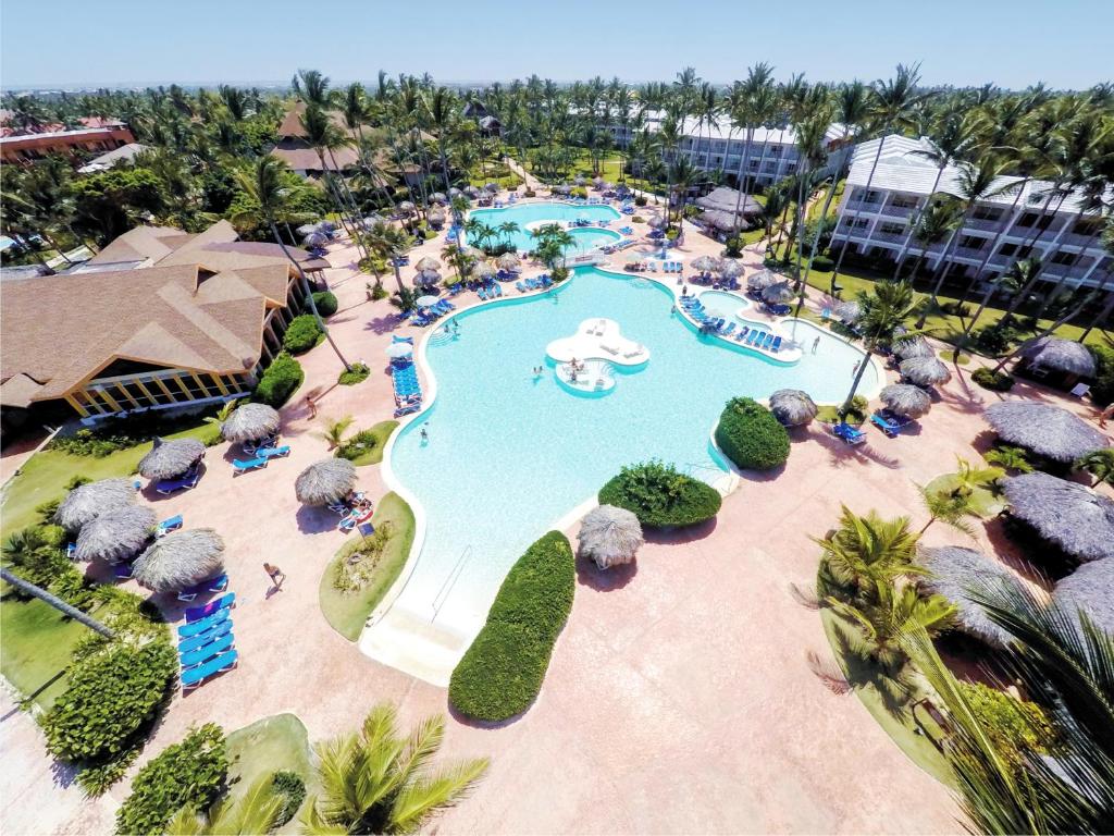 a beach with a pool, lawn chairs, and lawn chairs at VIK hotel Arena Blanca in Punta Cana
