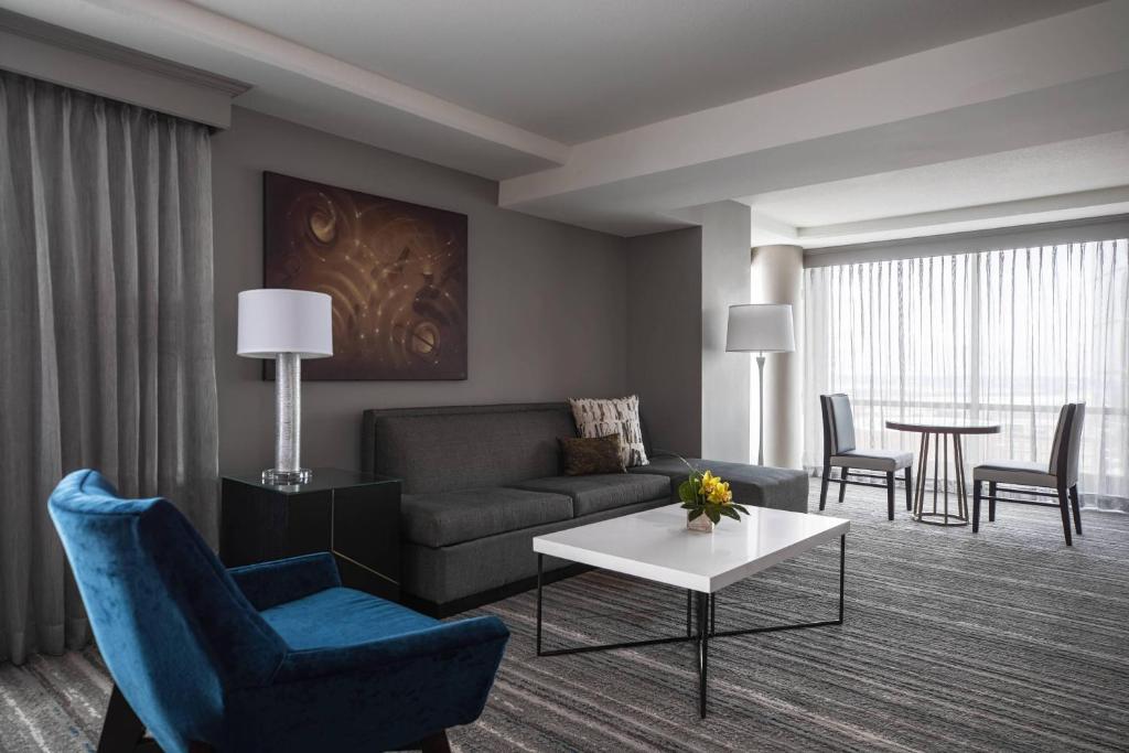 a living room with a couch and a table at Kansas City Marriott Downtown in Kansas City