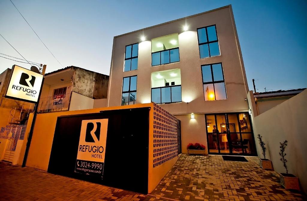 a building with a sign in front of it at Hotel Refugio in Maceió