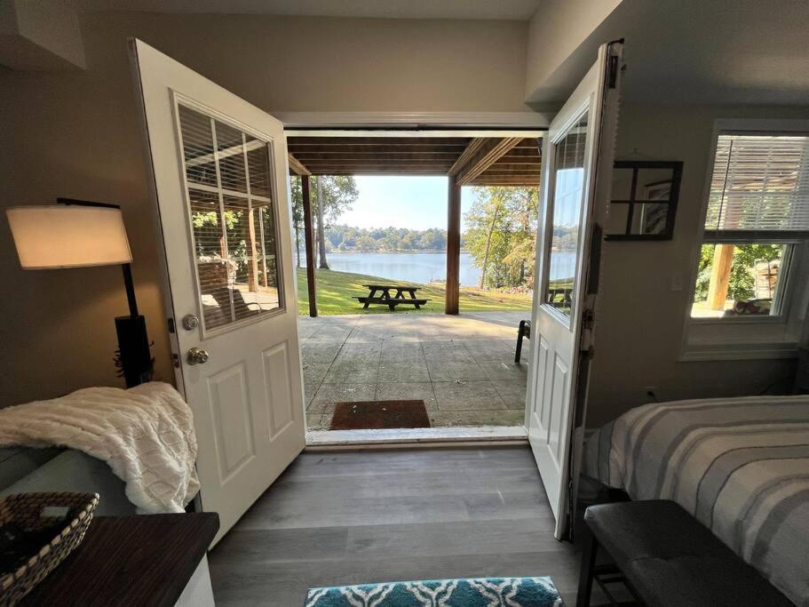 a bedroom with a door leading to a patio at Lakeside serenity in Newnan in Newnan