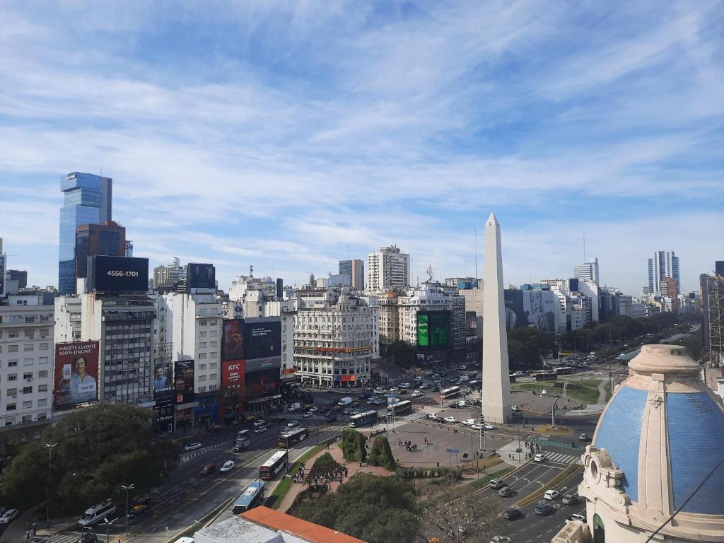 a view of a city with a obelisk in the middle at Vivi la mejor experiencia en el corazon de BA !!!! in Buenos Aires