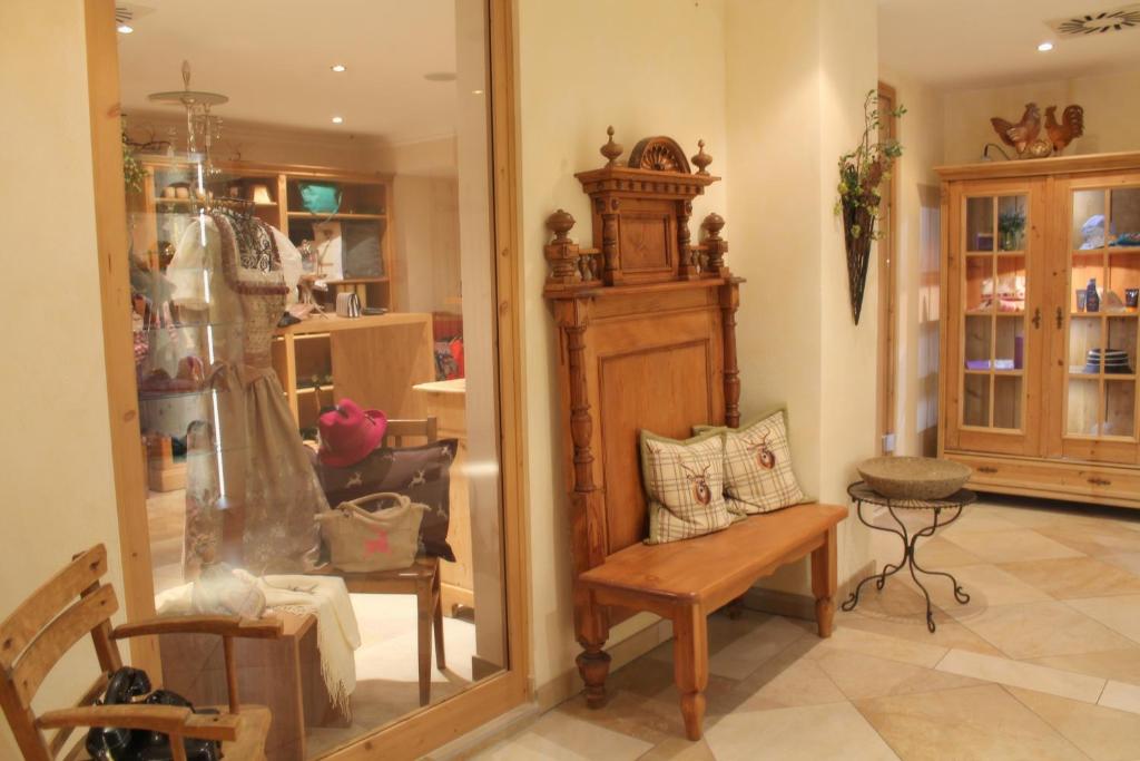 a living room with a chair and a mirror at Garden & SPA Hotel Das Götzfried in Regensburg