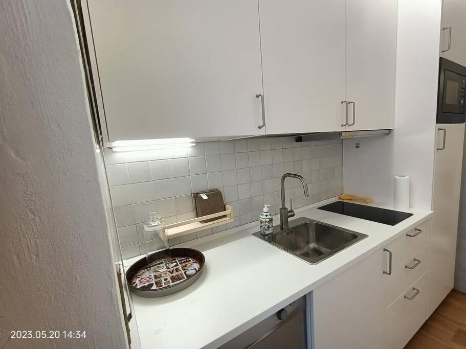 a kitchen with a sink and a counter top at Alloggio Asiago Centro (appartamento nuovo) in Asiago